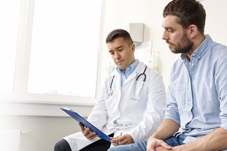 A doctor discussing a colon cancer diagnosis with a patient.